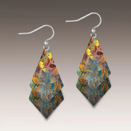 Multicolored layered earrings on a gray background