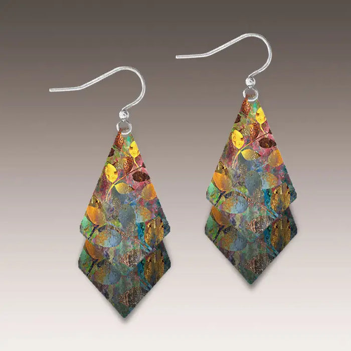Multicolored layered earrings on a gray background