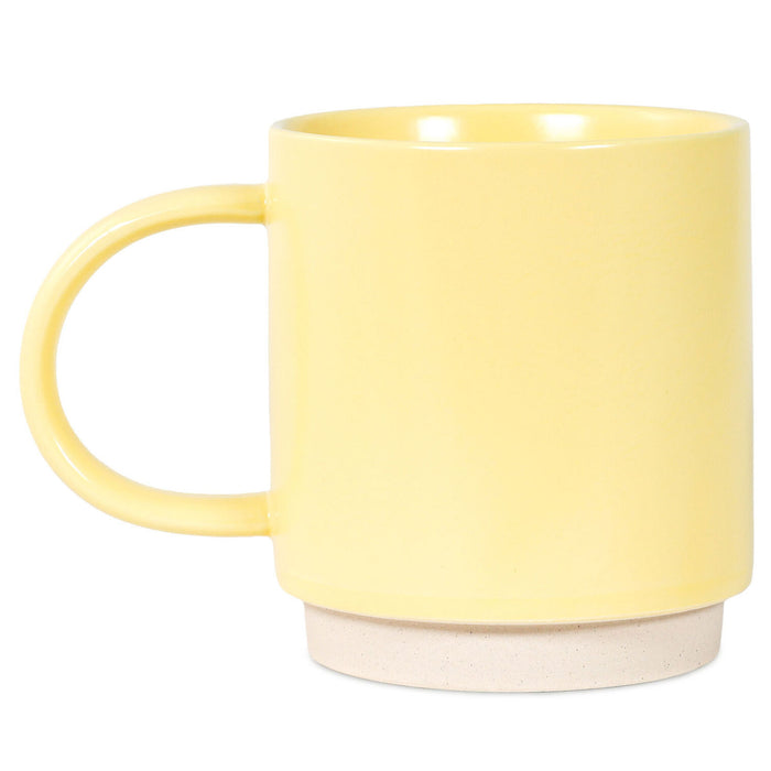 Yellow mug with a beige base on a white background
