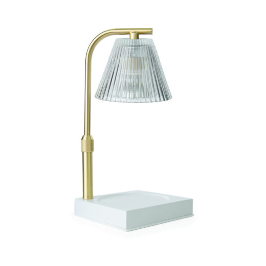 Modern table lamp with gold base and clear glass shade on a white background