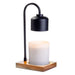 Table lamp with black adjustable arm and wooden base on a white background