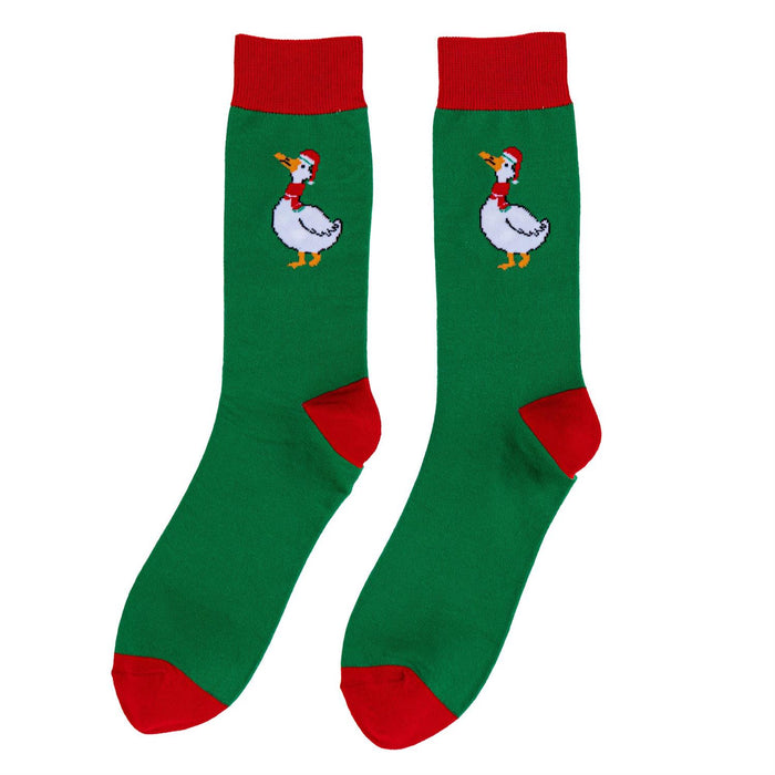 A pair of green crew socks with red cuffs, heels, and toes, featuring a cartoon white goose wearing a red Santa hat and scarf printed on each sock.