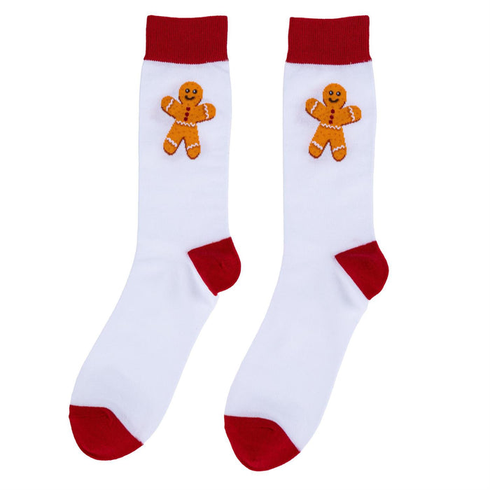 A pair of white crew socks with red cuffs, heels, and toes, featuring a gingerbread man graphic on the upper calf.