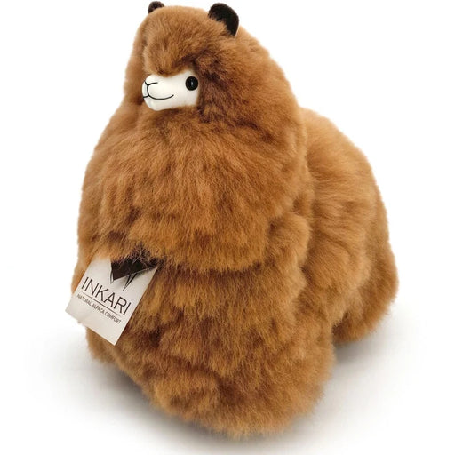 Brown plush toy with a visible brand tag on a white background