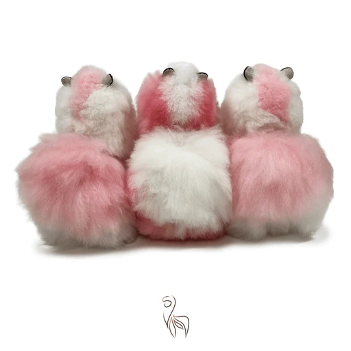 Three fluffy faux-fur sheep or alpaca figures shown from the back in pink and white, arranged side by side on a plain white background.