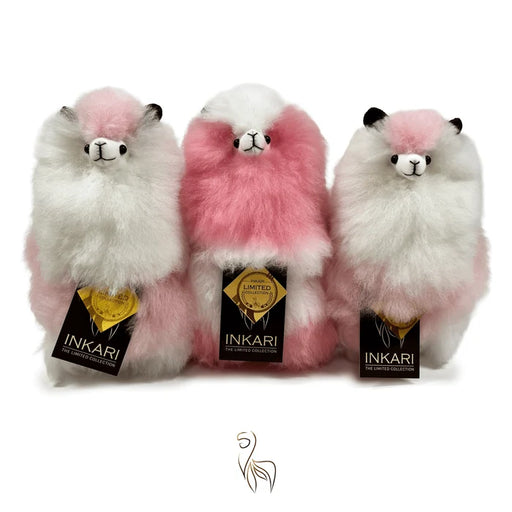 Three plush llamas with pink and white fur, each wearing an Inkari tag, on a white background.