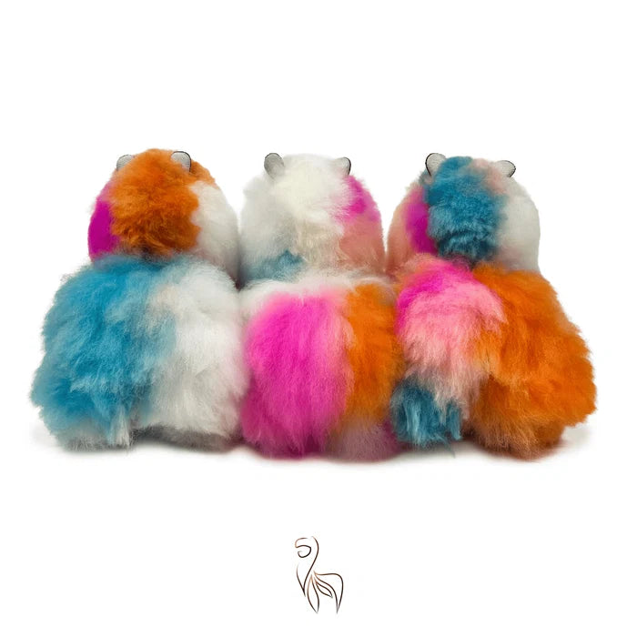 Colorful plush toys resembling hedgehogs on a white background