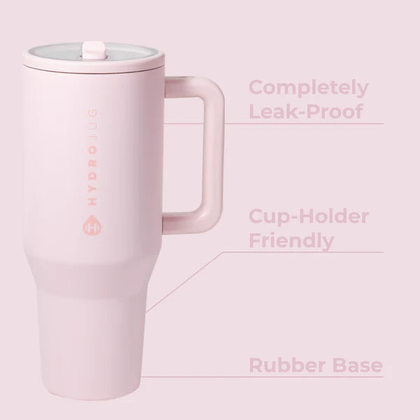 Pink travel mug with handle on a light pink background