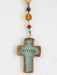 Cross-shaped pendant with 'Blessed' text and colorful beads on a white background