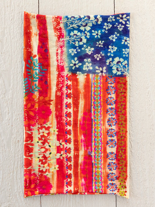 Colorful towel with floral and patterned design on a wooden surface
