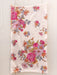 Floral patterned towel on a wooden surface