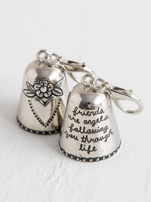 Silver bell charm with floral design and engraved text on a white background