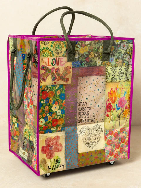 Colorful patchwork tote bag with floral patterns and text on a beige background