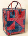 Red and blue patterned bag with wheels on a beige background