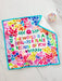 Colorful towel with floral design and motivational quote on a white surface