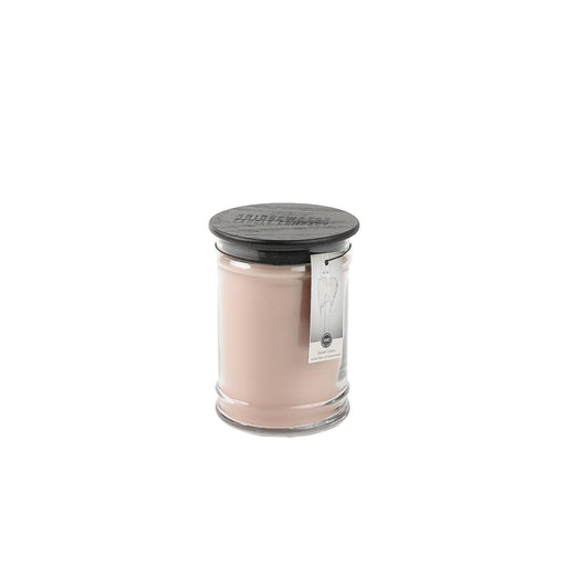 Pink candle with a black lid on a white background
