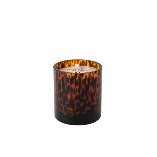 Tortoiseshell-patterned candle on a white background