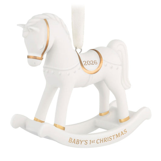 White rocking horse ornament with gold accents and 'Baby's 1st Christmas' text on a white background