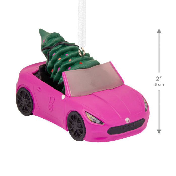 Pink toy car with a green Christmas tree inside, on a white background