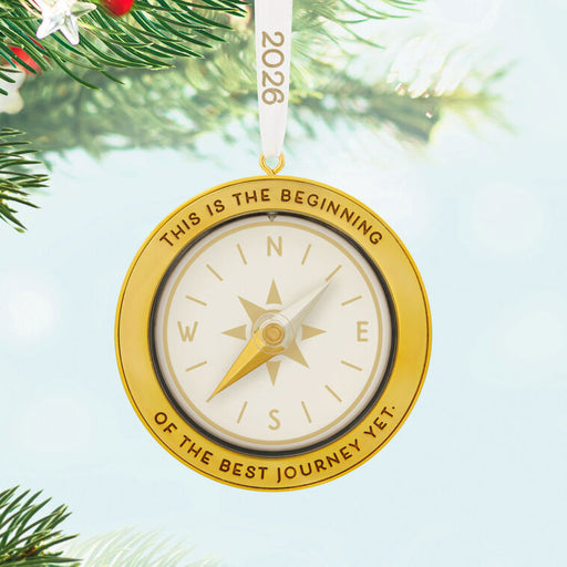 Gold compass ornament with text on a Christmas tree