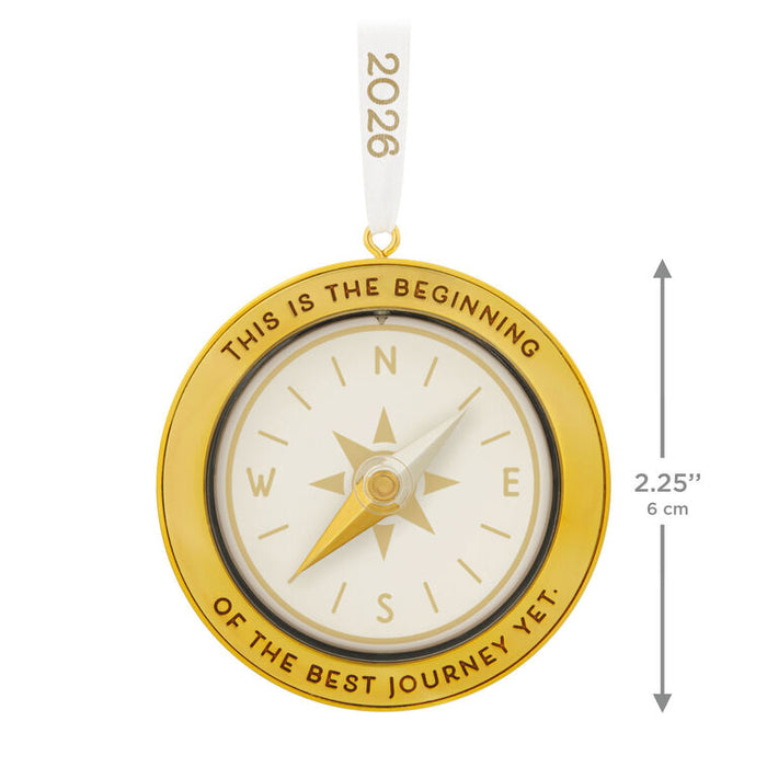 Gold compass ornament with 'This is the beginning of the best journey yet.' text on a white background