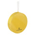 Yellow ornament with a white string on a white background