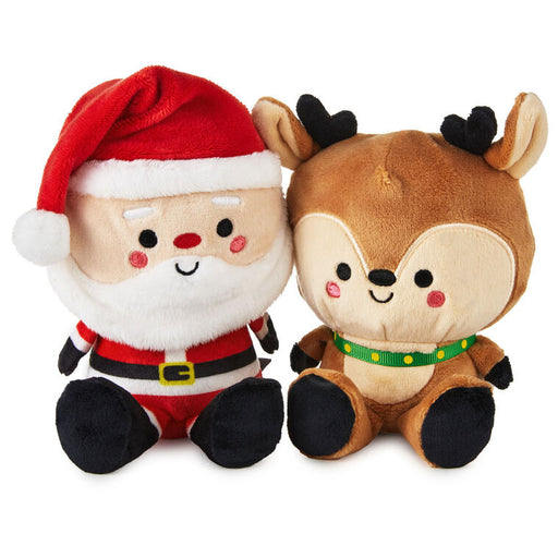 Plush toys of a Santa Claus and a reindeer on a white background