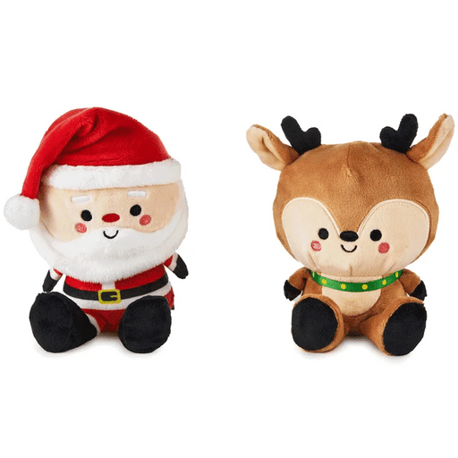 Plush toys of Santa Claus and a reindeer on a white background