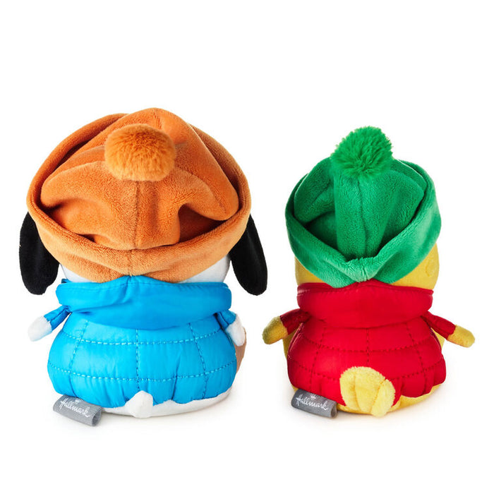 Two plush toys with colorful hats on a white background