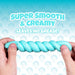 Turquoise dog toy with text 'Super Smooth & Creamy, Leaves No Grease!' on a blue background.