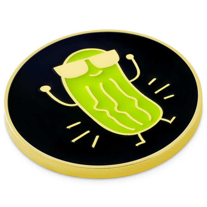 A round black and gold enamel pin featuring a cartoon pickle wearing yellow sunglasses, shown on a plain white background.