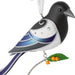 Decorative bird ornament with blue, black, and white colors on a white background
