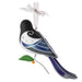 Decorative bird ornament with blue and black design on a white background