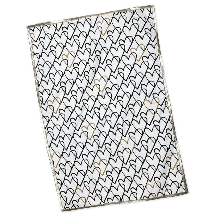 Folded fabric with a black heart pattern on a white background