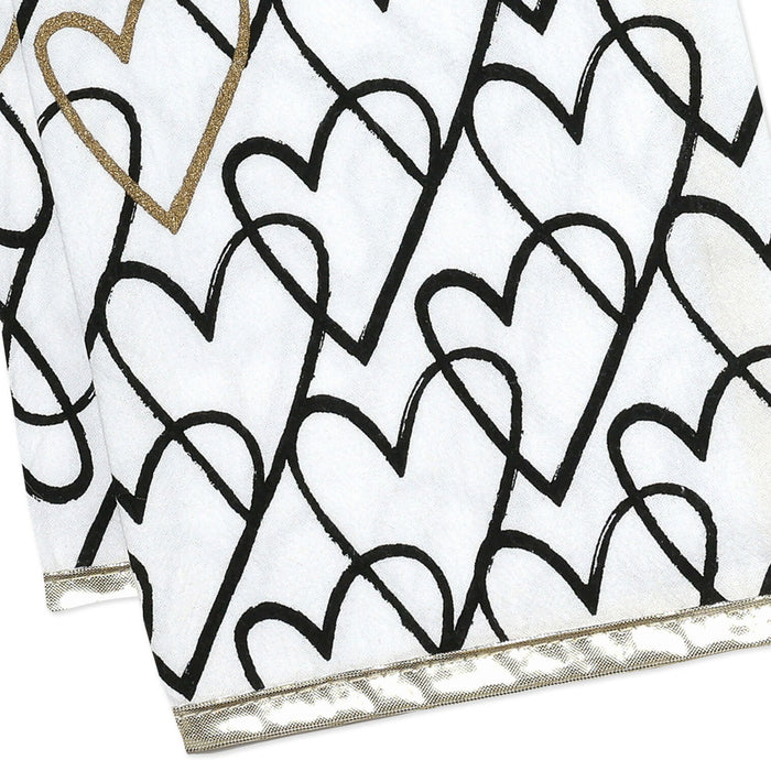 White fabric with black heart patterns and gold accents