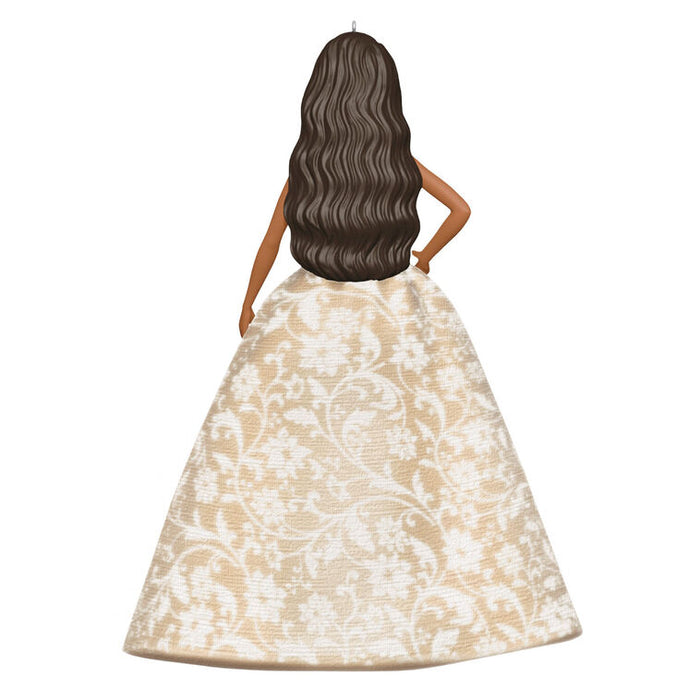 Doll wearing a beige floral dress on a white background