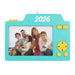 Turquoise camera-shaped photo frame with '2026' and a family photo inside, on a white background.
