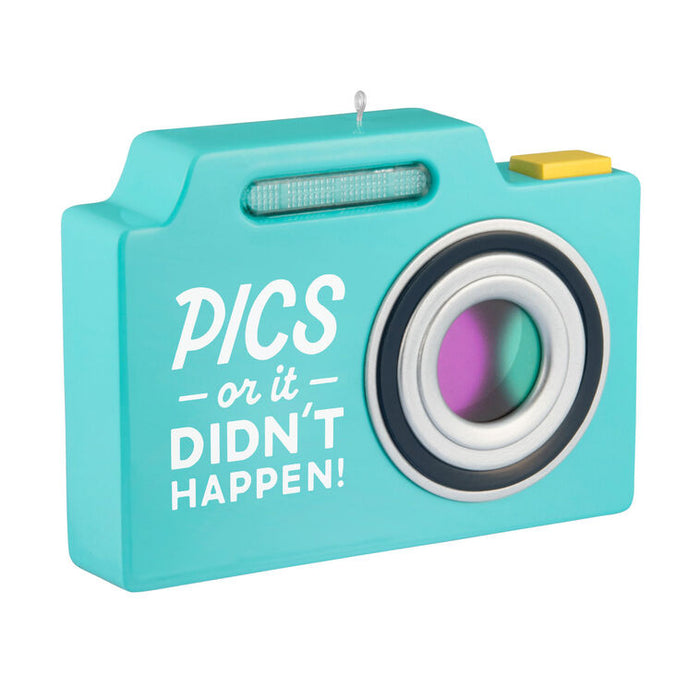 Turquoise camera-shaped candle with 'PICS or it Didn't Happen!' text on a white background