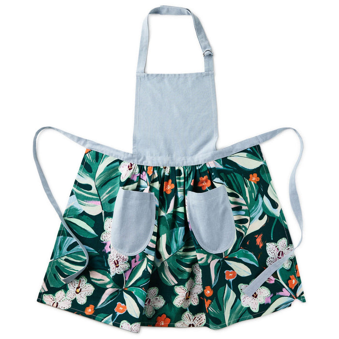 Children's apron with a tropical leaf pattern on a white background