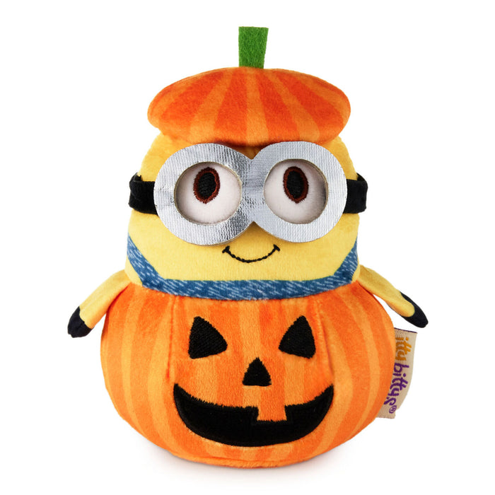 A plush toy combining a Minions character with a jack-o'-lantern pumpkin, featuring an orange striped pumpkin body, a yellow Minions head with goggles, a blue scarf, and a green stem on top, photographed on a white background.