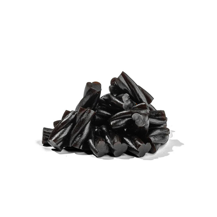 Pile of black licorice sticks on a white background