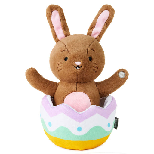 Plush toy rabbit in a colorful egg-shaped container on a white background