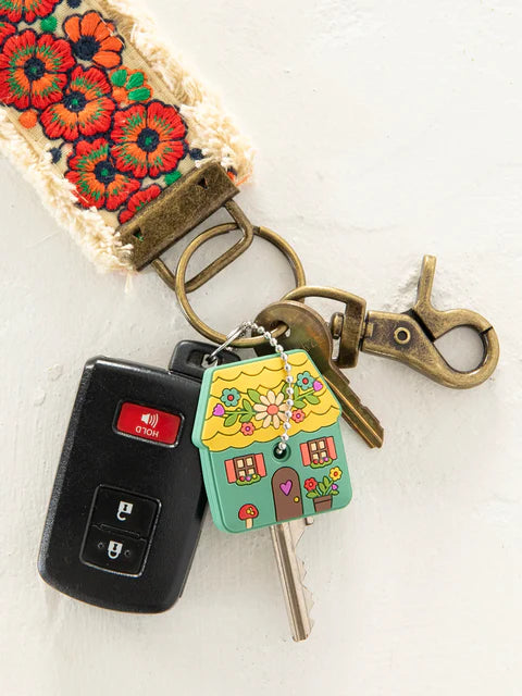 Keychain with house design and colorful floral pattern on a white background