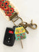 Keychain with house design and colorful floral pattern on a white background