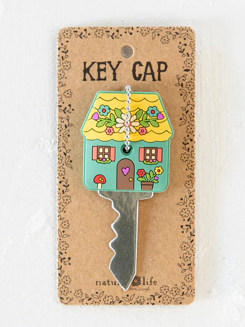 Decorative key cap with house design on a cardboard backing
