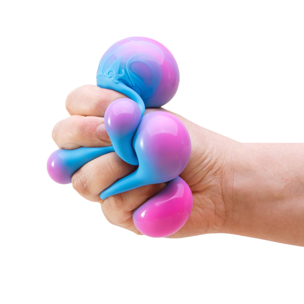 Hand holding a pink and blue stress ball on a white background