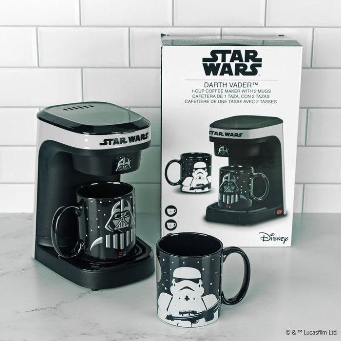 Star Wars coffee maker with Darth Vader and Stormtrooper mugs on a tiled wall background