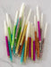 Colorful glittery straws on a white surface