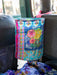 Colorful floral-patterned bag hanging on a car seat