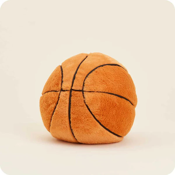 Plush basketball toy on a beige background